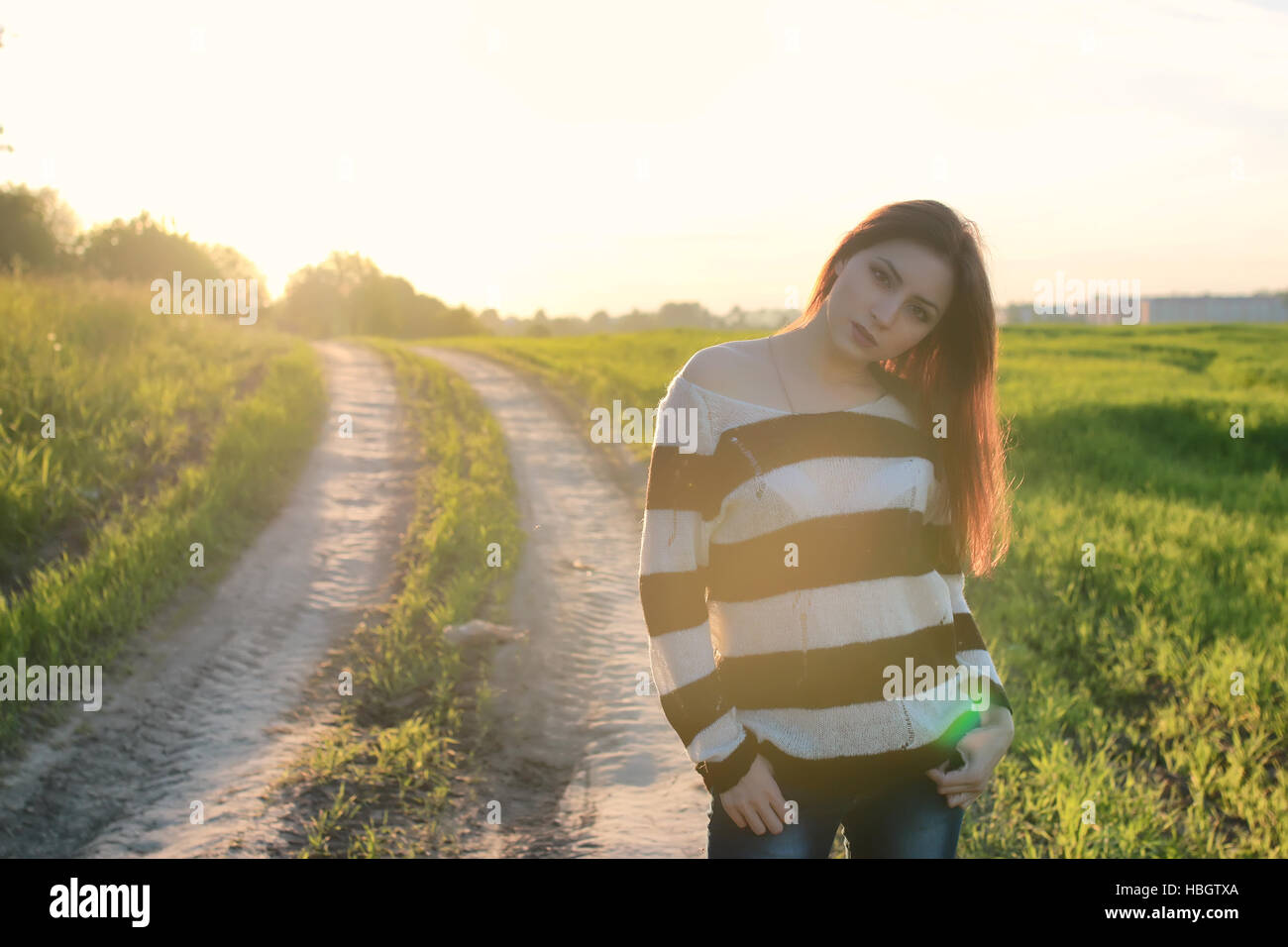 girl fashion in the field on sunset Stock Photo - Alamy