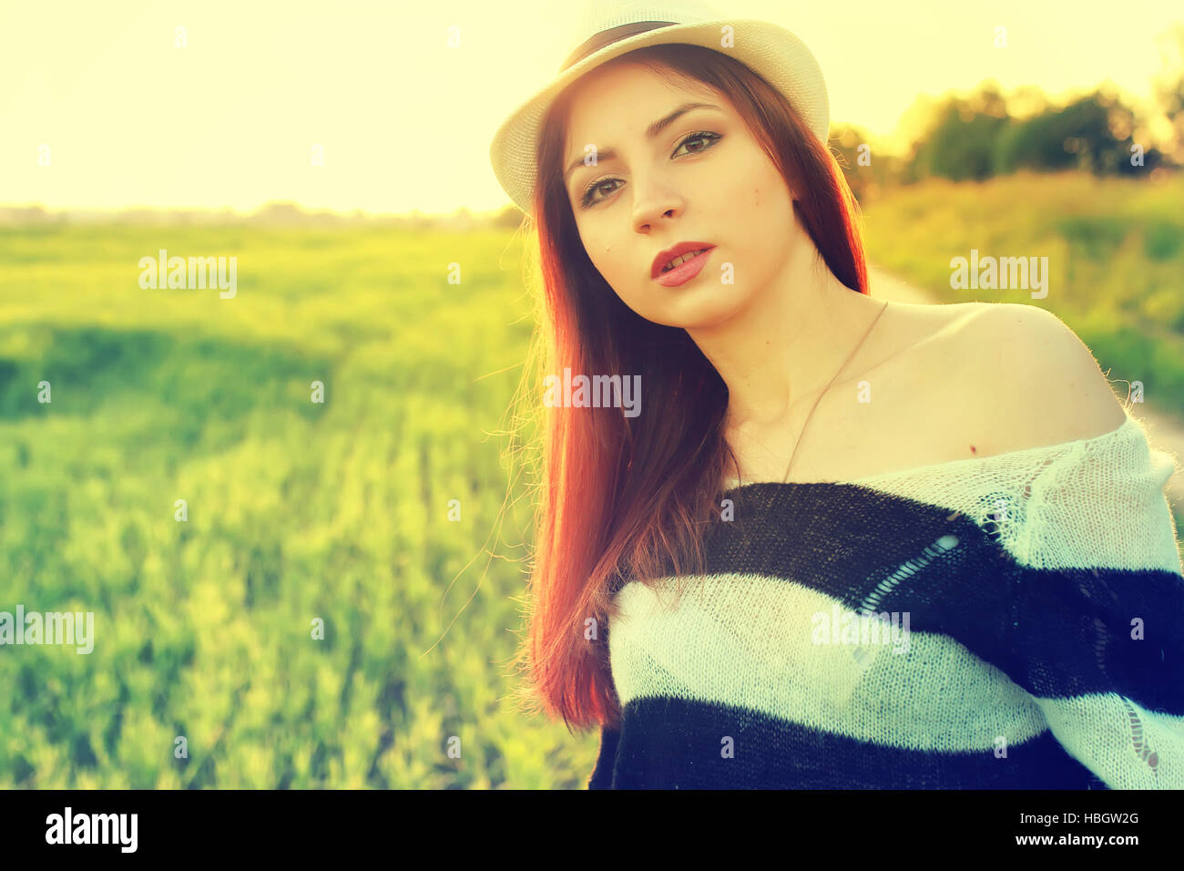 girl in hat fashion field sunset Stock Photo Alamy