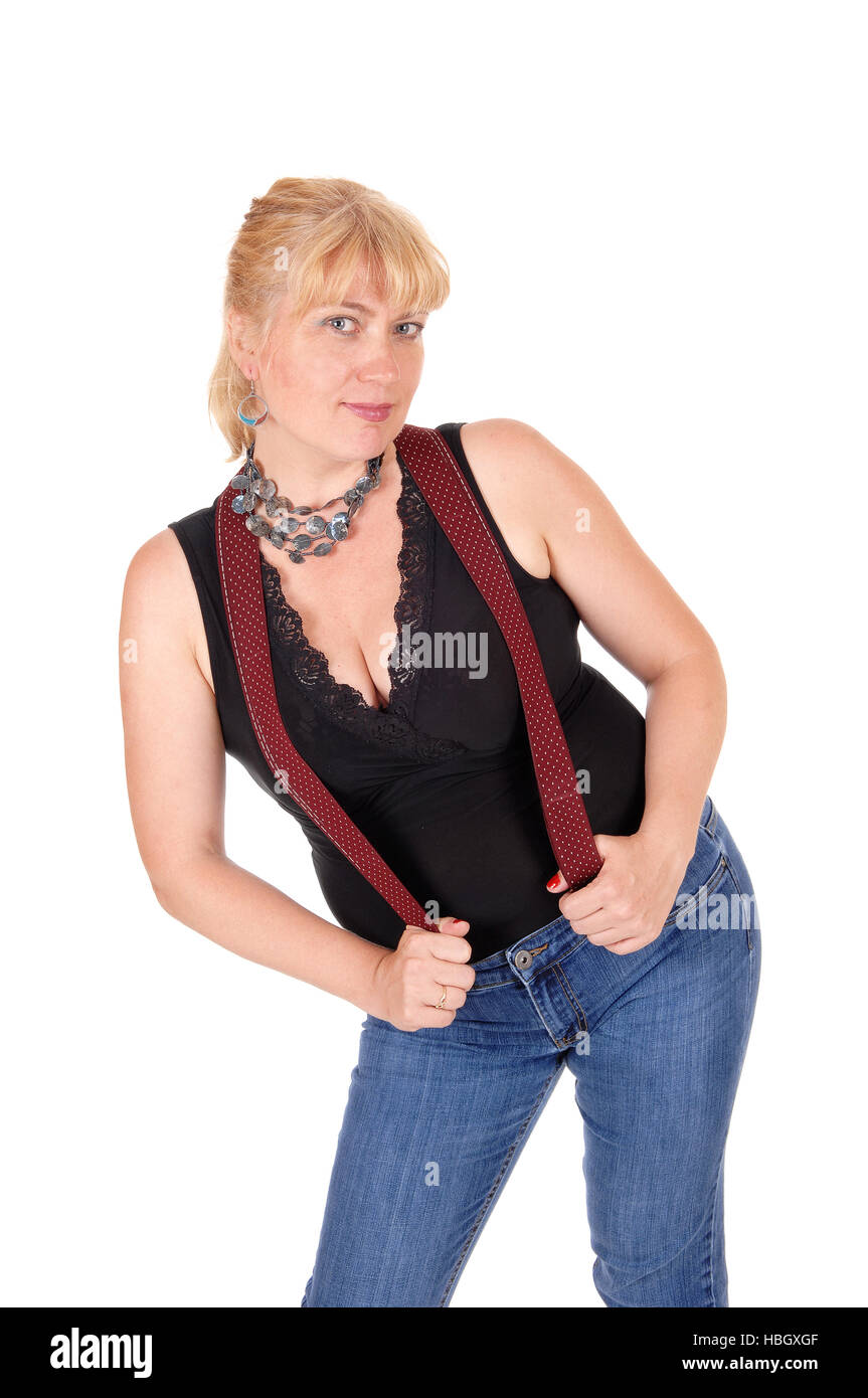 Pretty woman standing with suspenders. Stock Photo