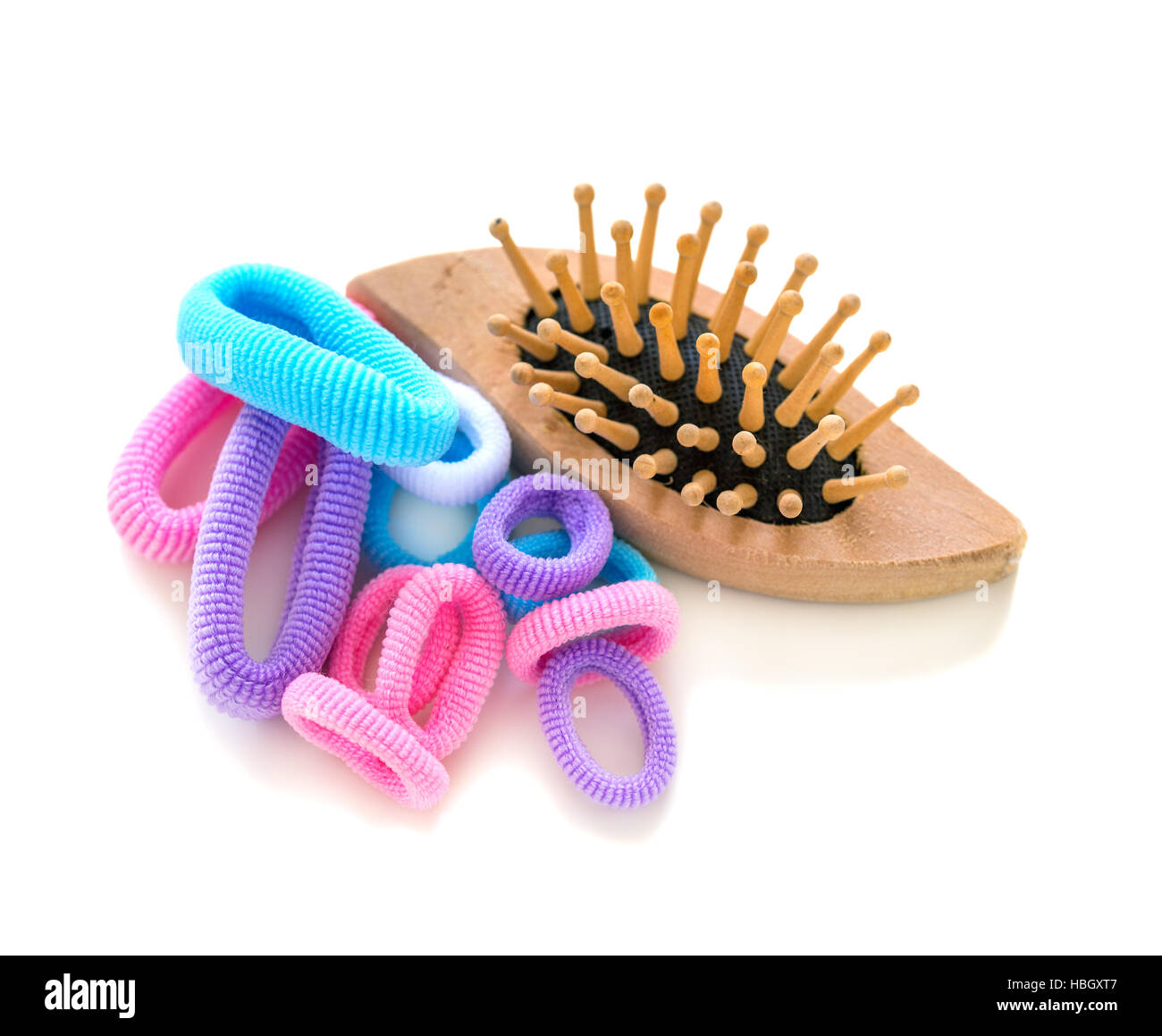 Wooden brush and rubber bands for hair. Stock Photo