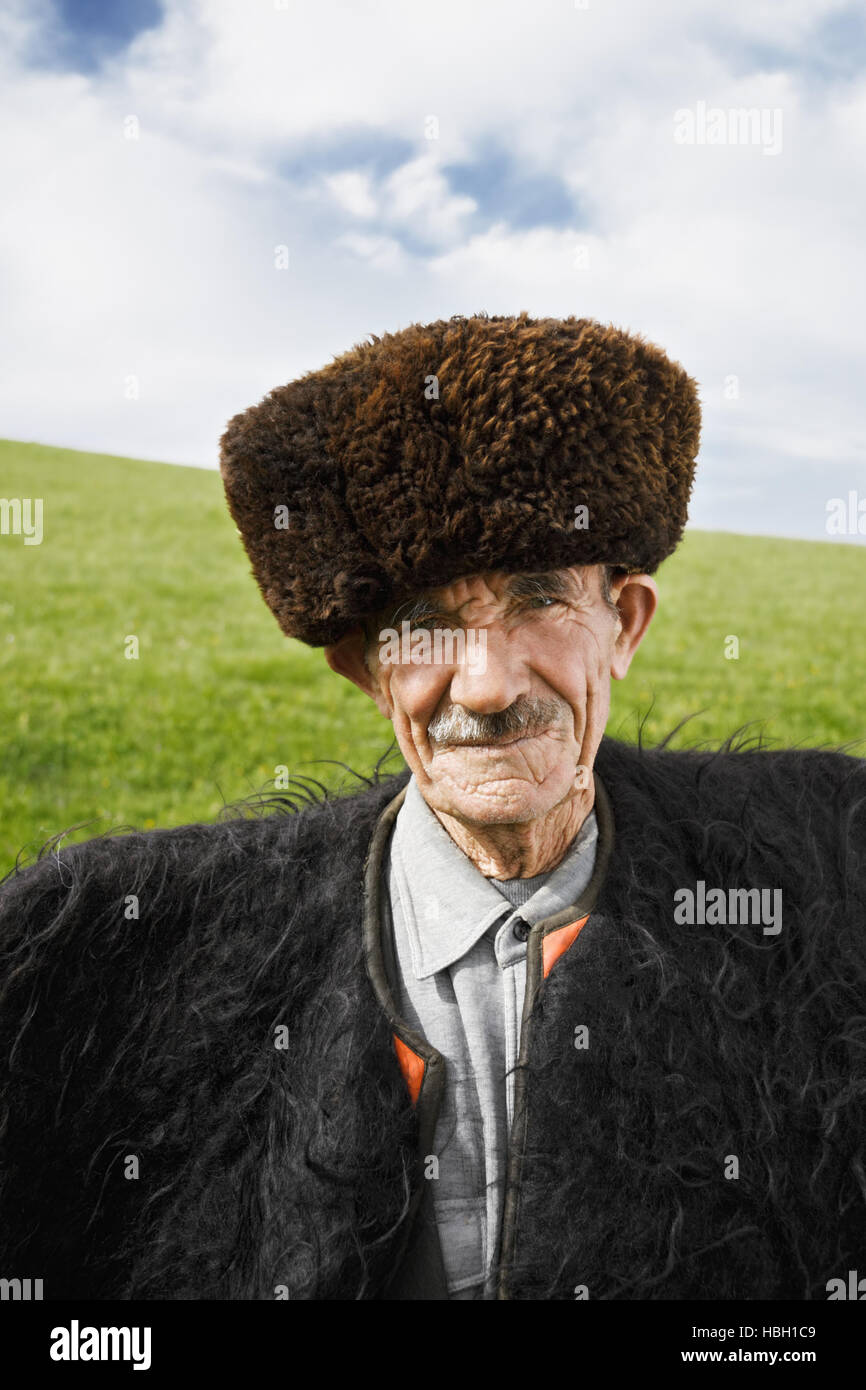 Elderly man in felt cloak Stock Photo