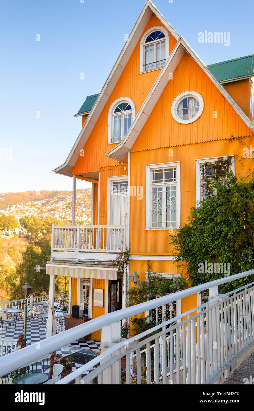 A flash of orange brightens a lofty hillside in Valparaiso, Chile Stock Photo