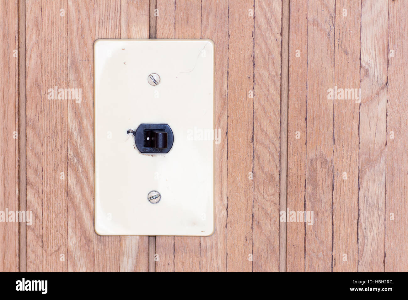 Japanese retro electrical switch on the wooden wall l as the switch set on with a copyspace on the right Stock Photo
