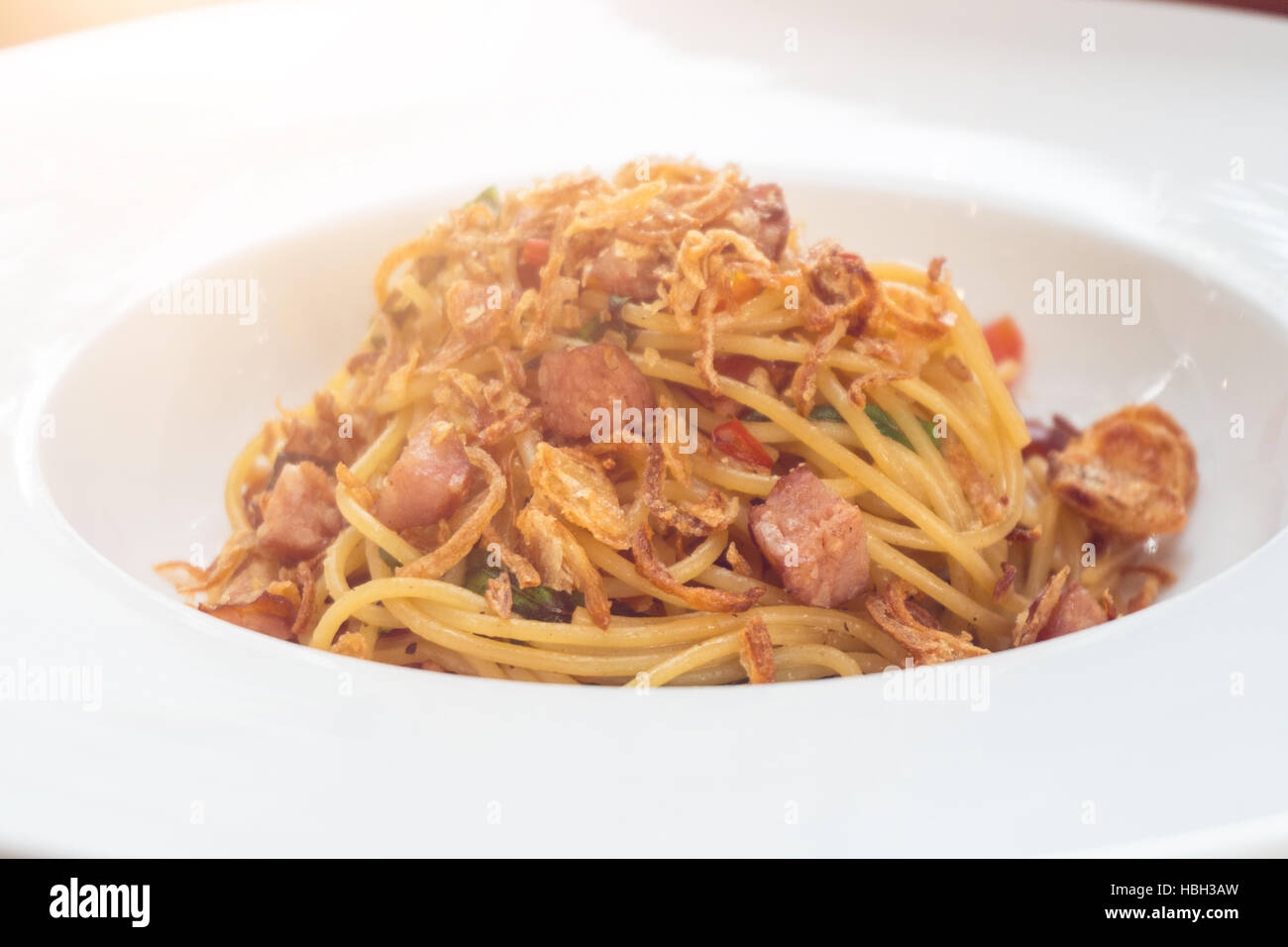 Spaghetti on white dish and sunlight. Stock Photo
