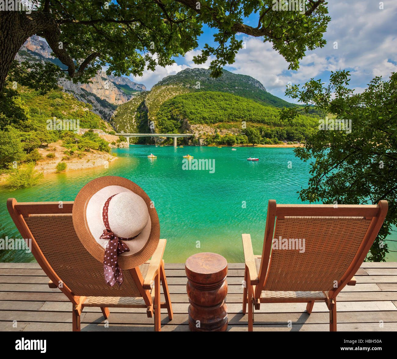 Two chairs and straw hat on the platform Stock Photo - Alamy
