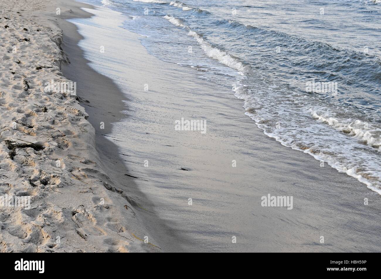 Waves on a sandy beach Stock Photo - Alamy