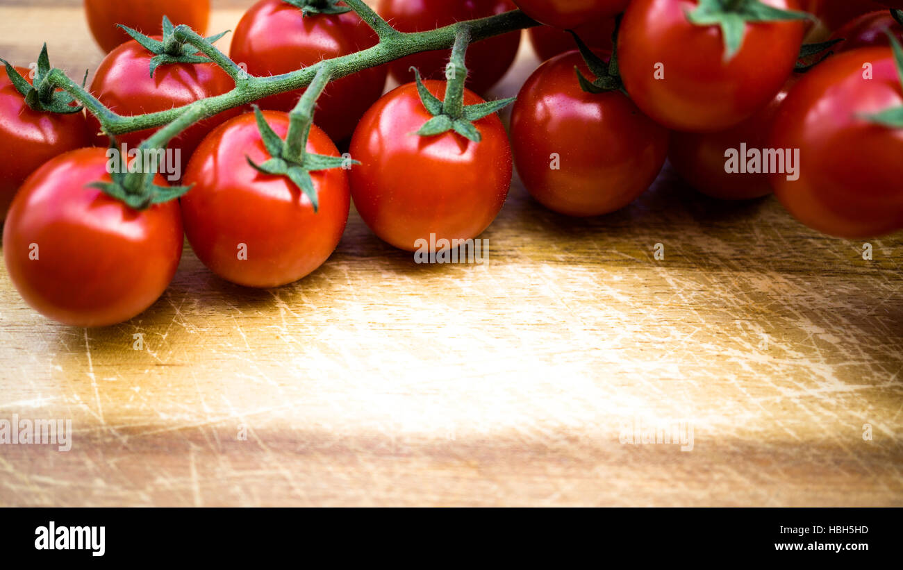 red juicy tomatoes on a cutting board Stock Photo - Alamy