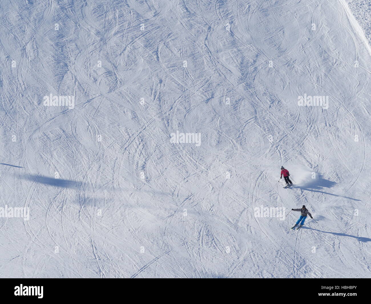 people riding down ski slope Stock Photo