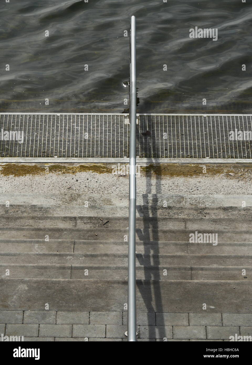 Close-up of steps with railing towards waterfront Stock Photo