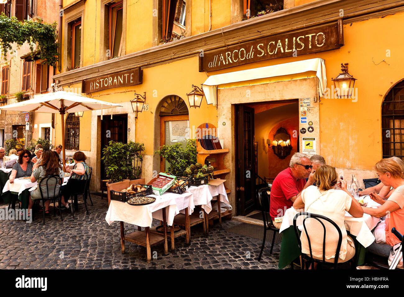Rome, Italy - May 27, 2016: Unidentified people eating traditional italian food in outdoor restaurant in Trastevere district in Rome, Italy. Stock Photo