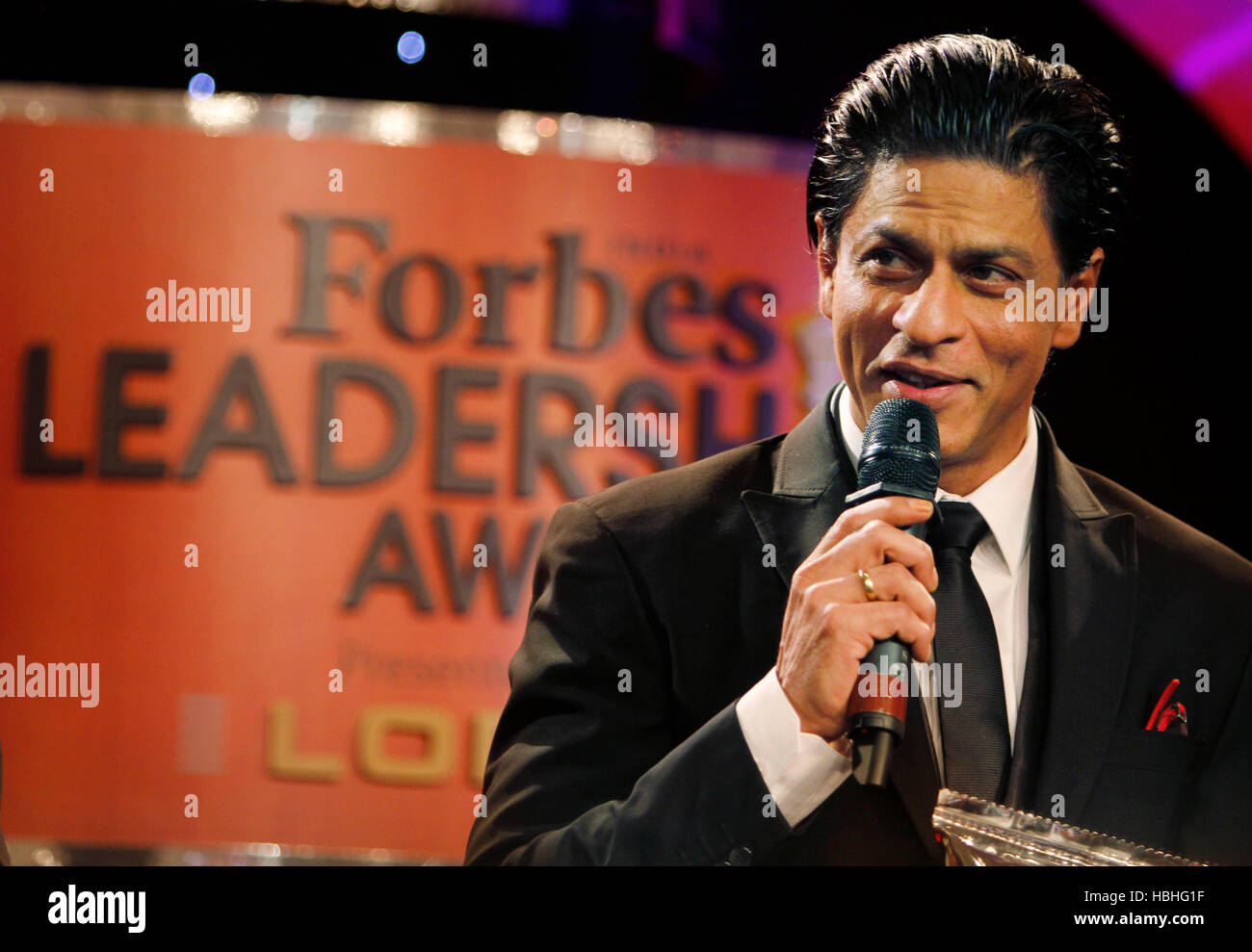 Shahrukh Khan, Indian Bollywood actor, speaking on microphone at Forbes Leadership Awards in Mumbai, India Stock Photo