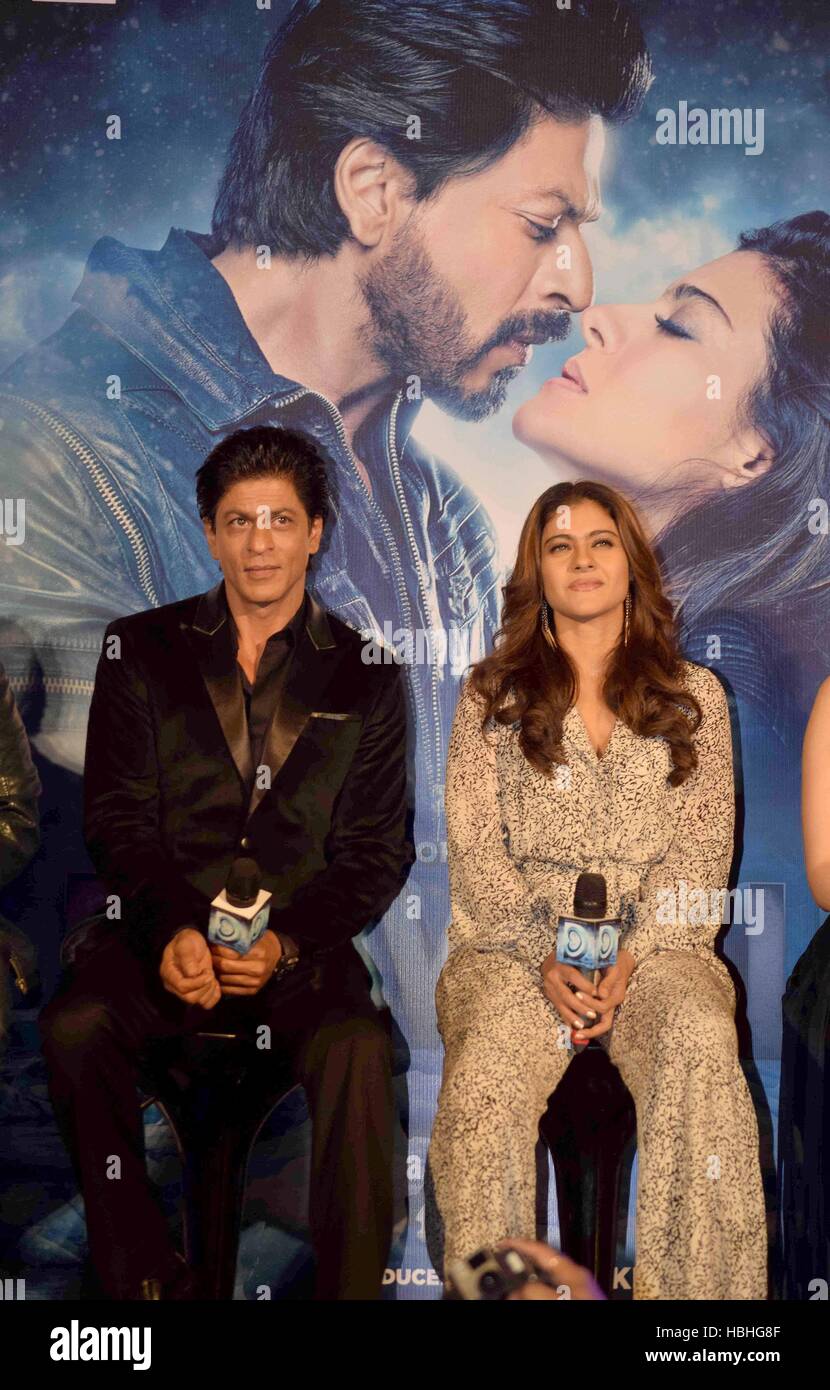 Shah Rukh Khan, Indian Bollywood actor and actress Kajol sitting with microphones at film Dilwale song launch in Mumbai, India Stock Photo