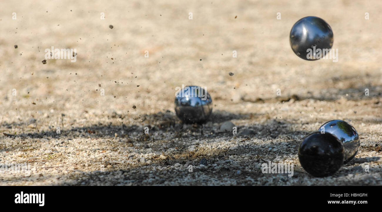 Metallic petanque three balls and a small wood jack, France Stock Photo