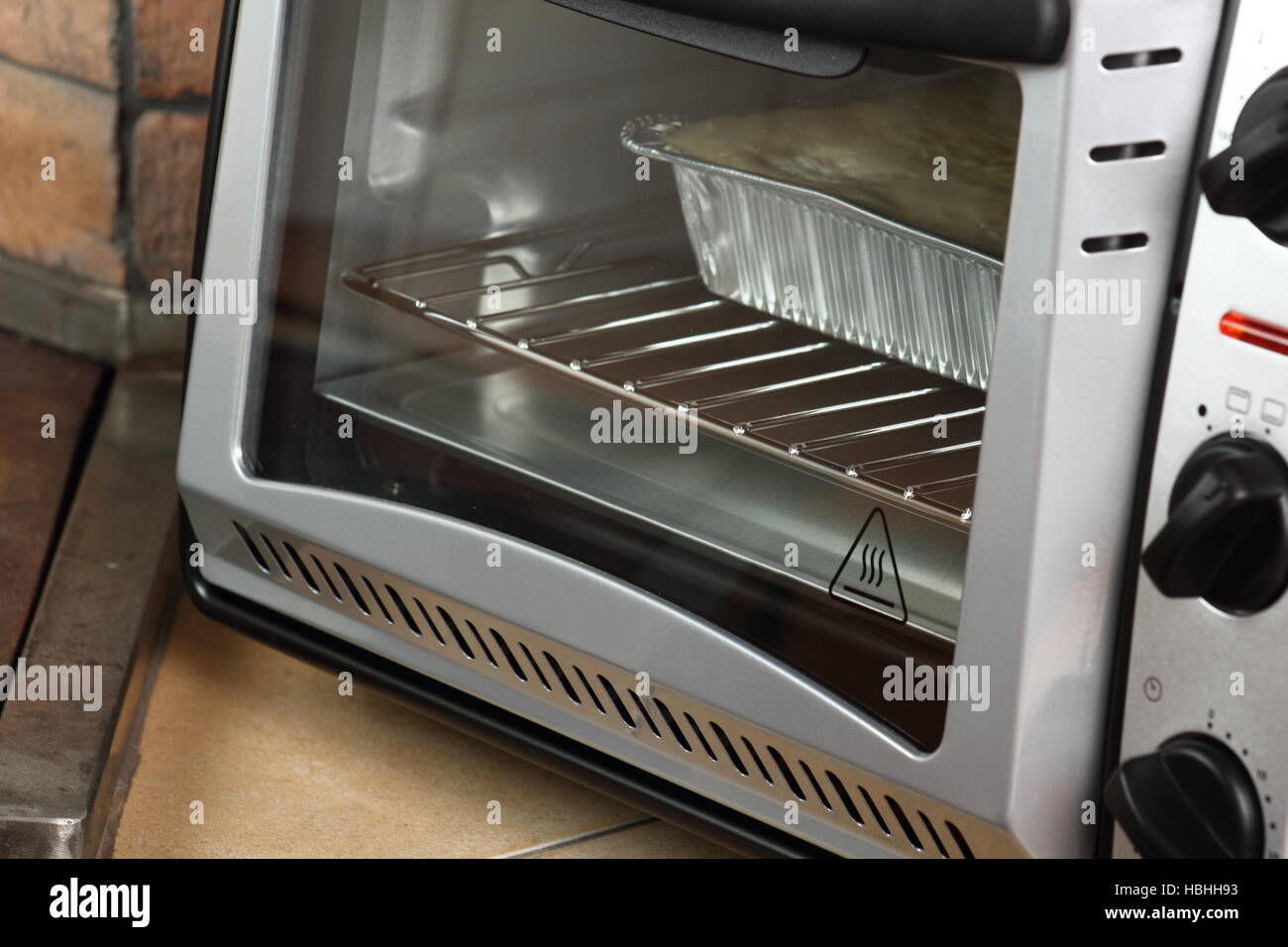 Baking Lasagne Bolognese in Disposable Foil Dish in Electric Oven Stock