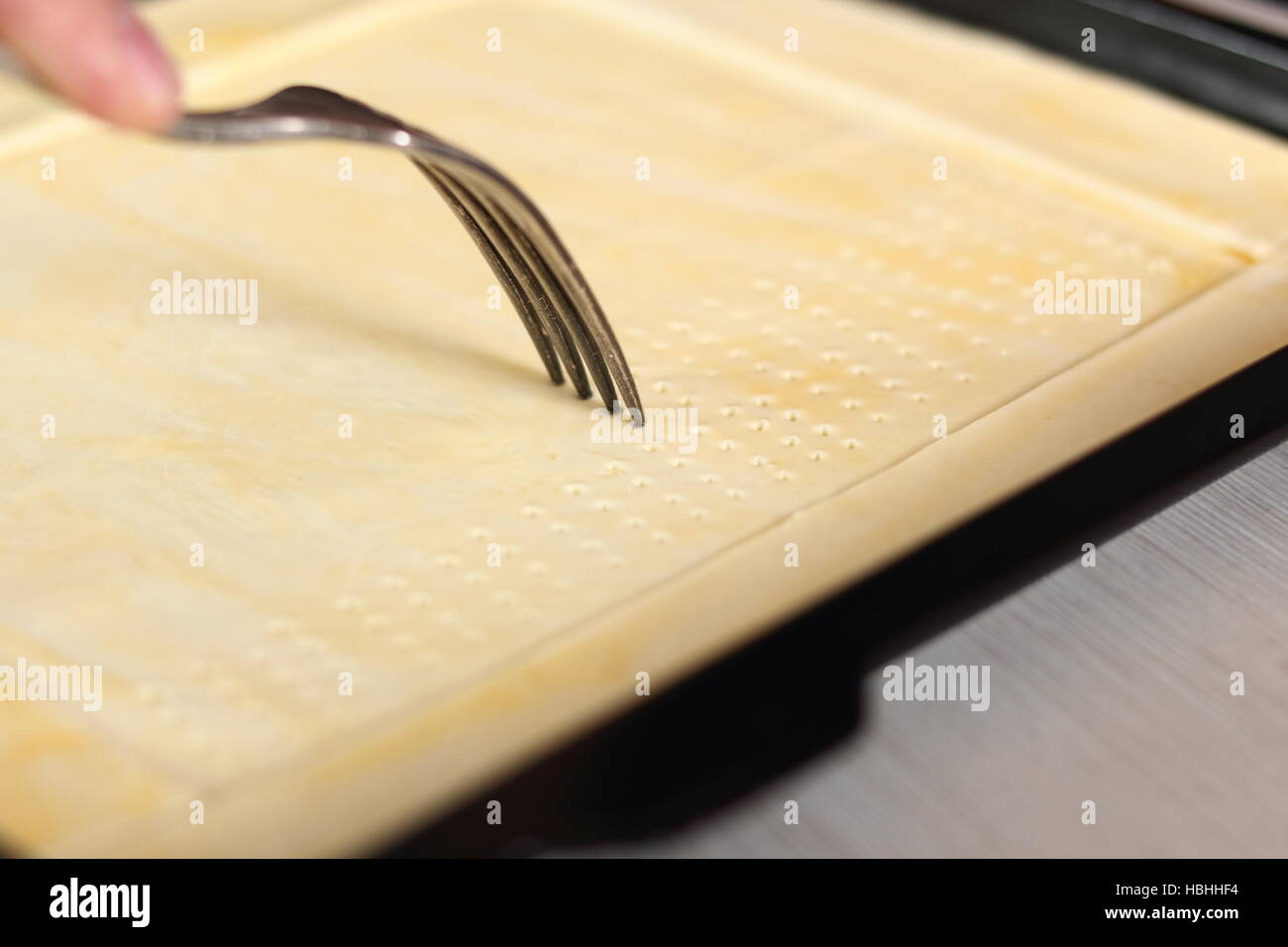 Prick base of puff pastry sheet with fork. Making Chicken and Egg Galette Series Stock Photo Alamy