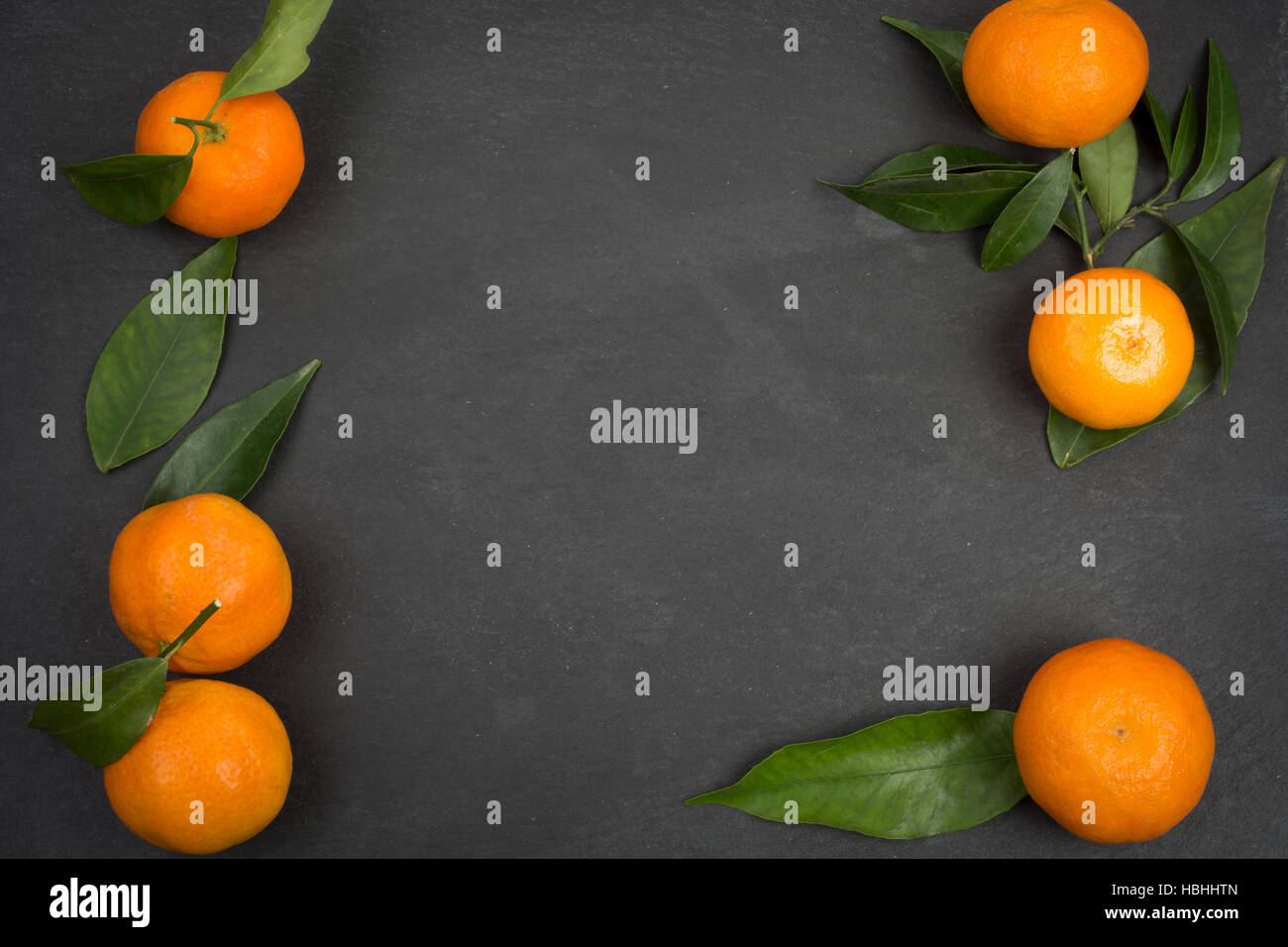 Dark slate table with tangerine fruits for background with copy space Stock Photo