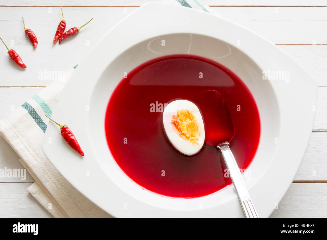 Traditional clear red beetroot soup - borscht - with egg Stock Photo