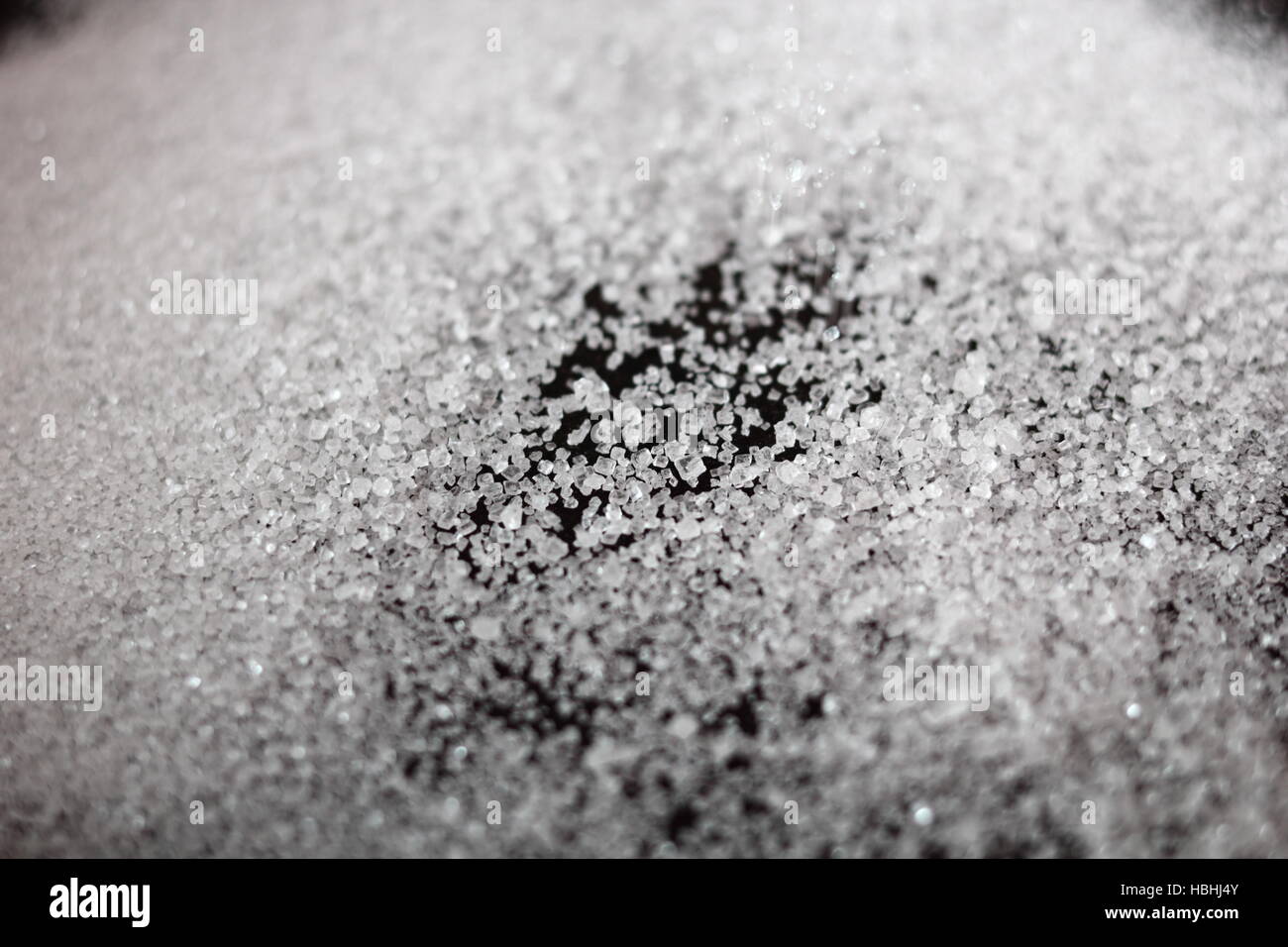 Sugar sprinkled in frying pan. Making Pear Tarte Tatin with Cardamom series. Stock Photo