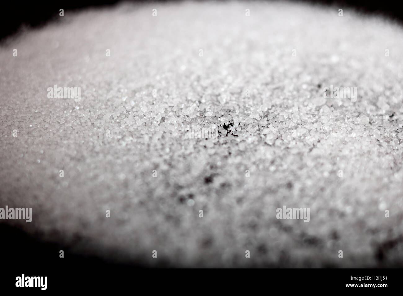 Sugar sprinkled in frying pan. Making Pear Tarte Tatin with Cardamom