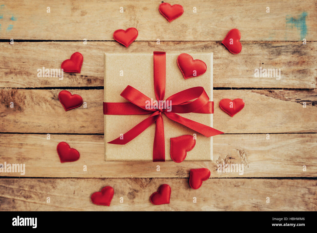 Top view (above) gift box and red ribbon and red heart for valentine on table wooden. Valentine background. Stock Photo