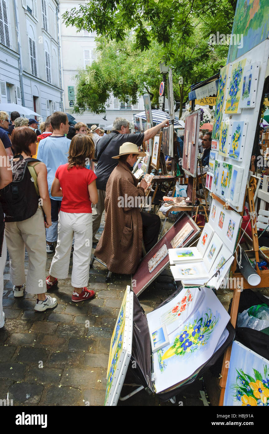 View of a section of Place du Tertre, woman painting at the square in ...