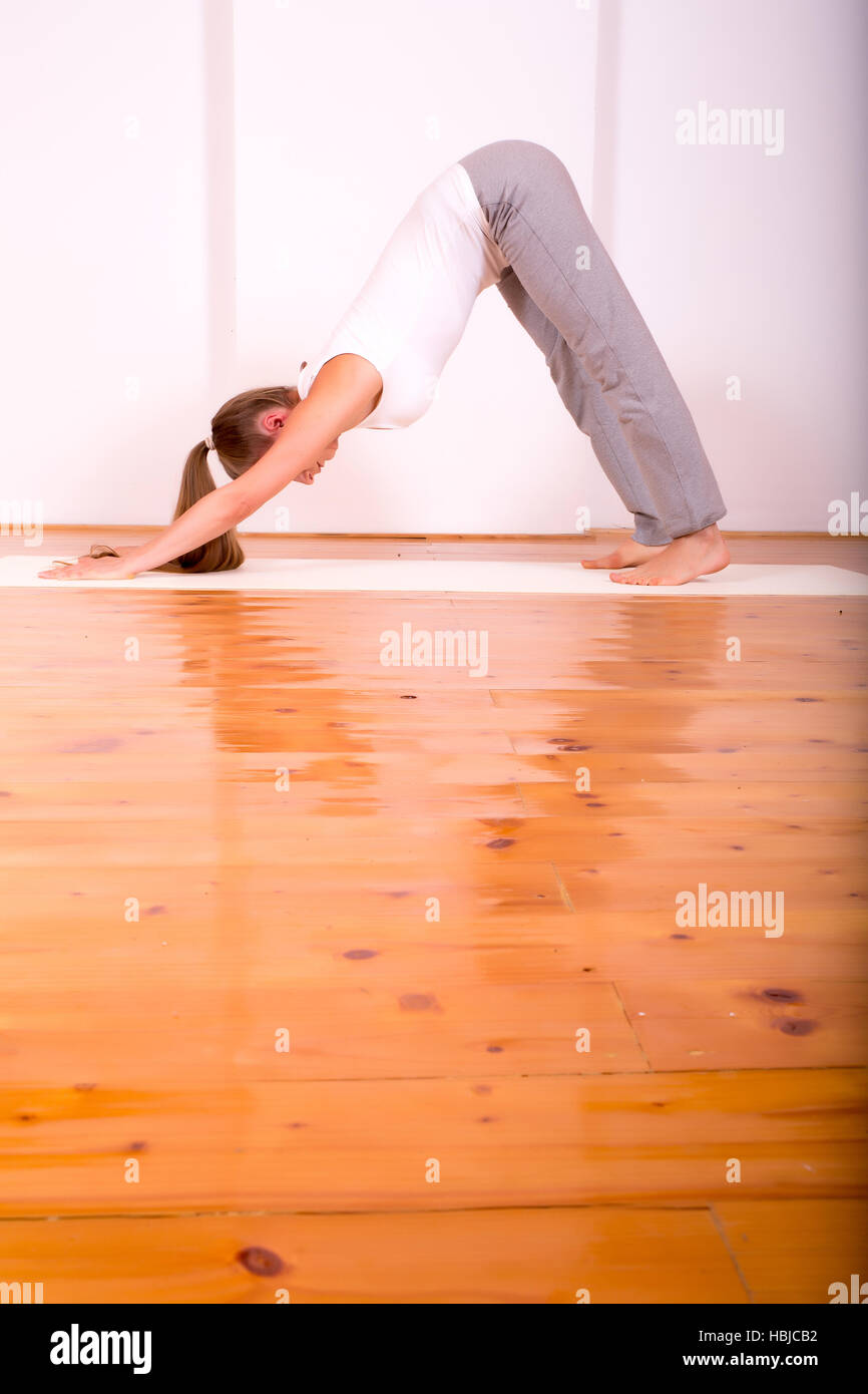 Woman practicing Yoga in a Studio Stock Photo - Alamy