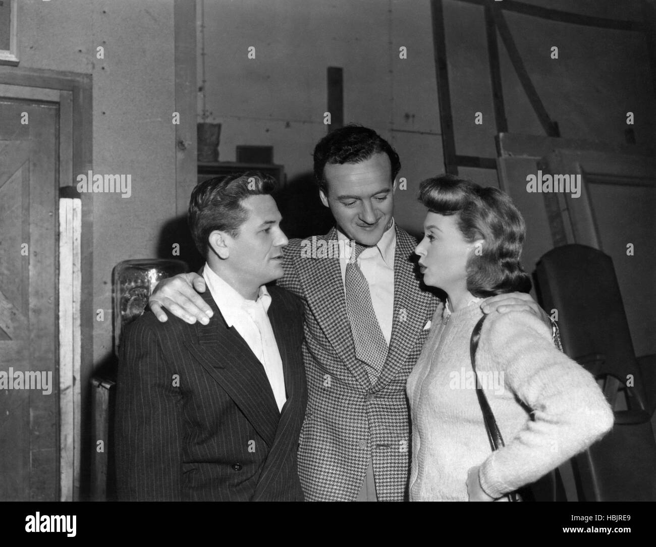 BODY AND SOUL, David Niven, (center), visits John Garfield, Lilli