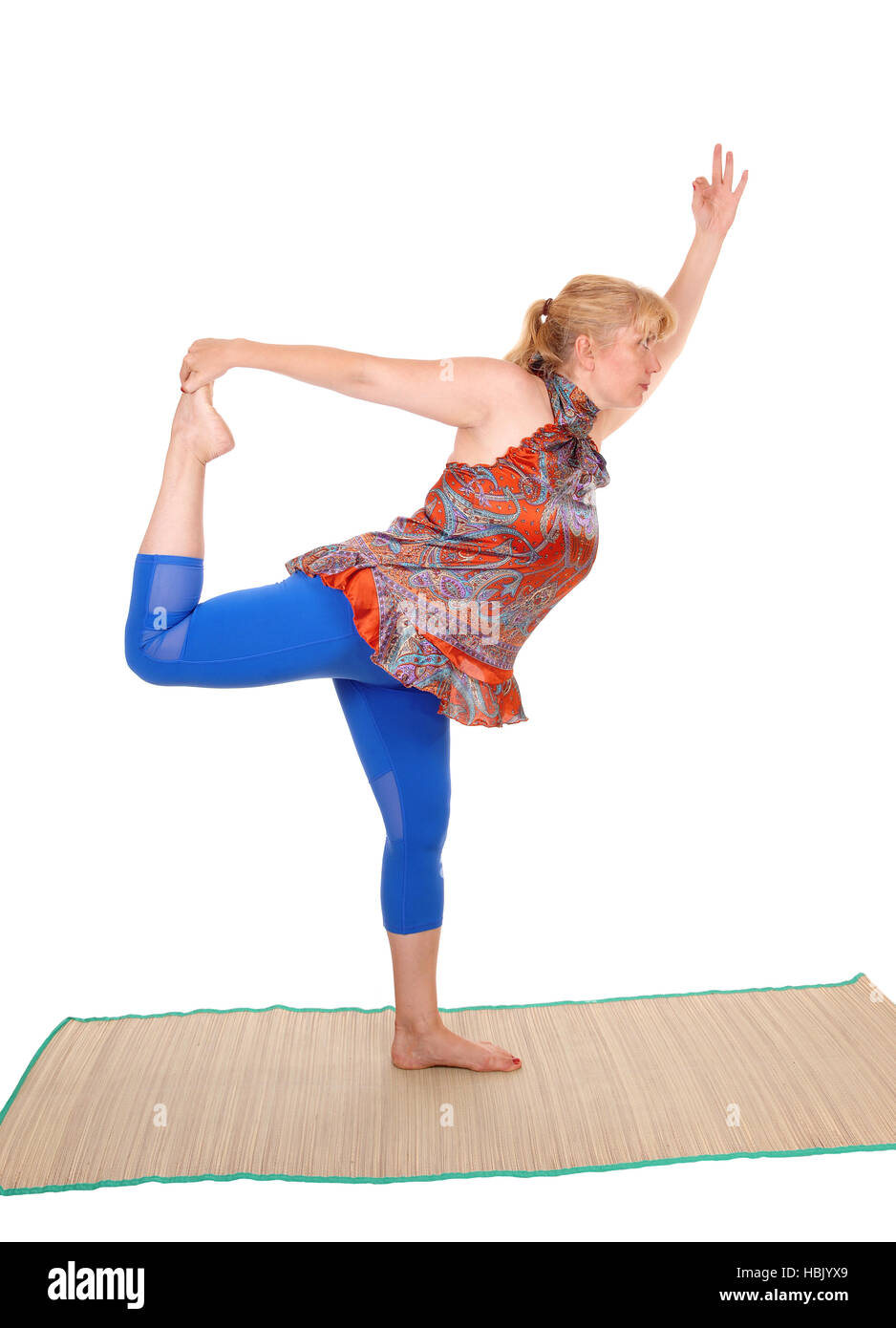Yoga trainer standing on one leg . Stock Photo