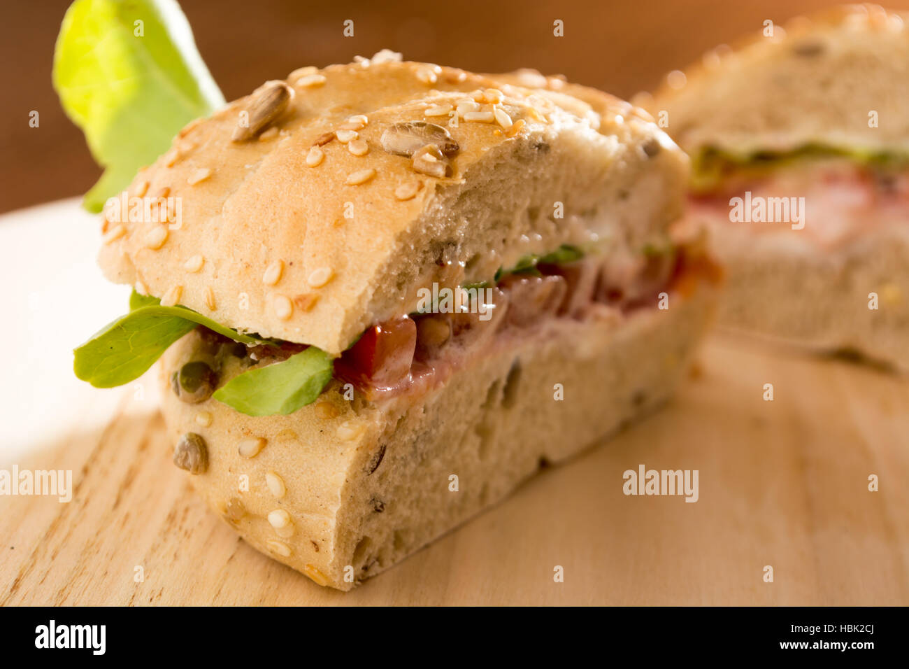 Sandwich cut in half with fresh smoked meat Stock Photo