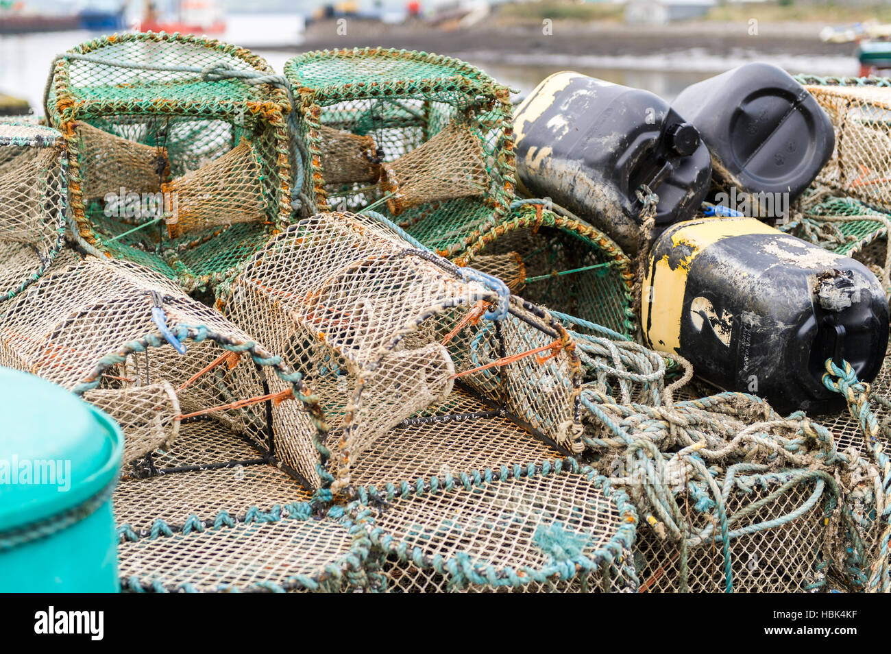 Stack of creels or crab and/or lobster pots on the dock in harbour in Ireland. Stock Photo
