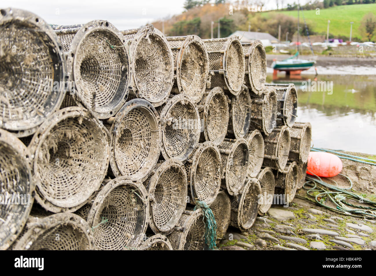 Stack of creels or crab and/or lobster pots on the dock in harbour in Ireland. Stock Photo