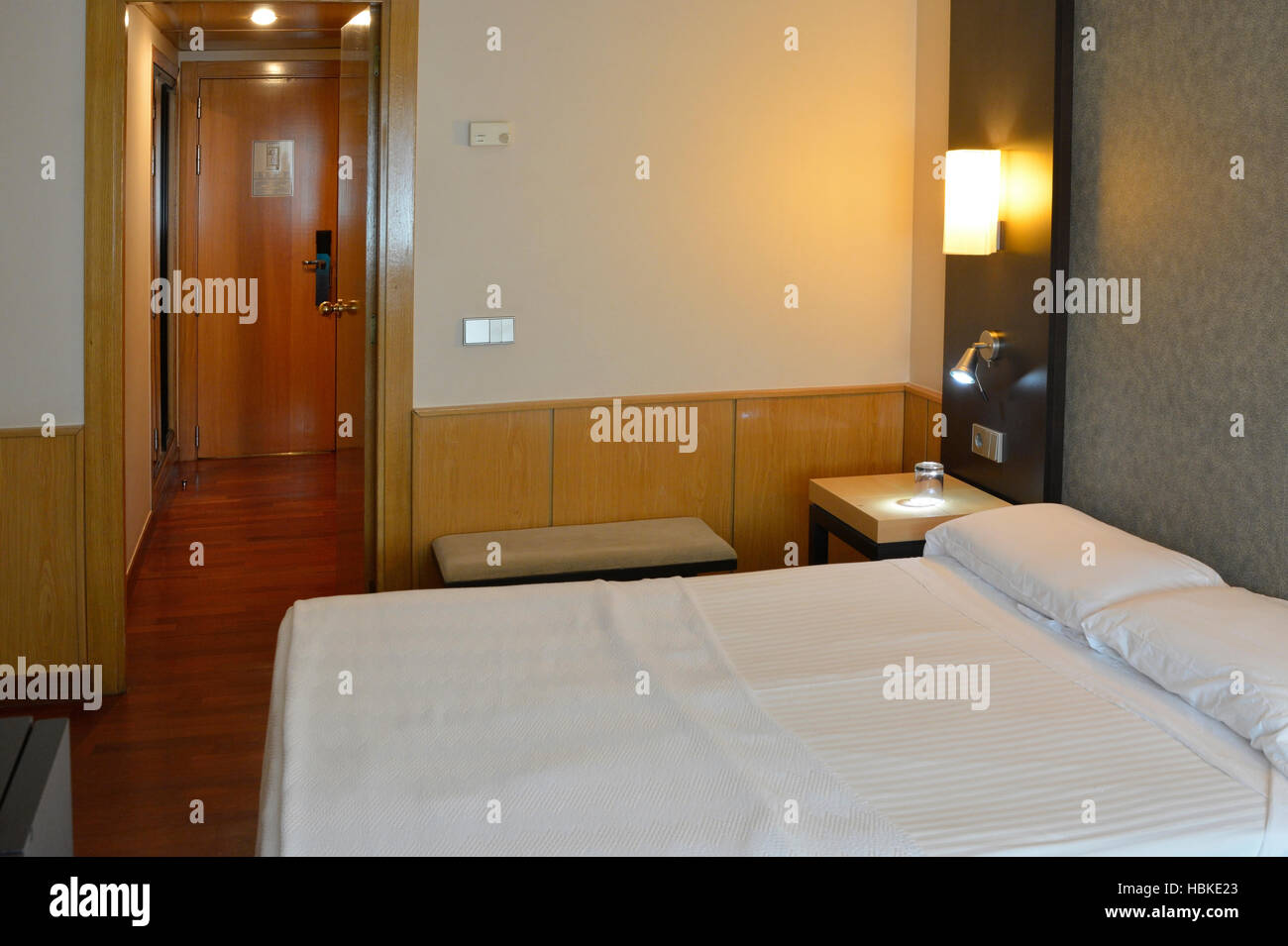 Modern hotel room, double bed with bedside tables, telephone and lamps. Valencia, Spain Stock