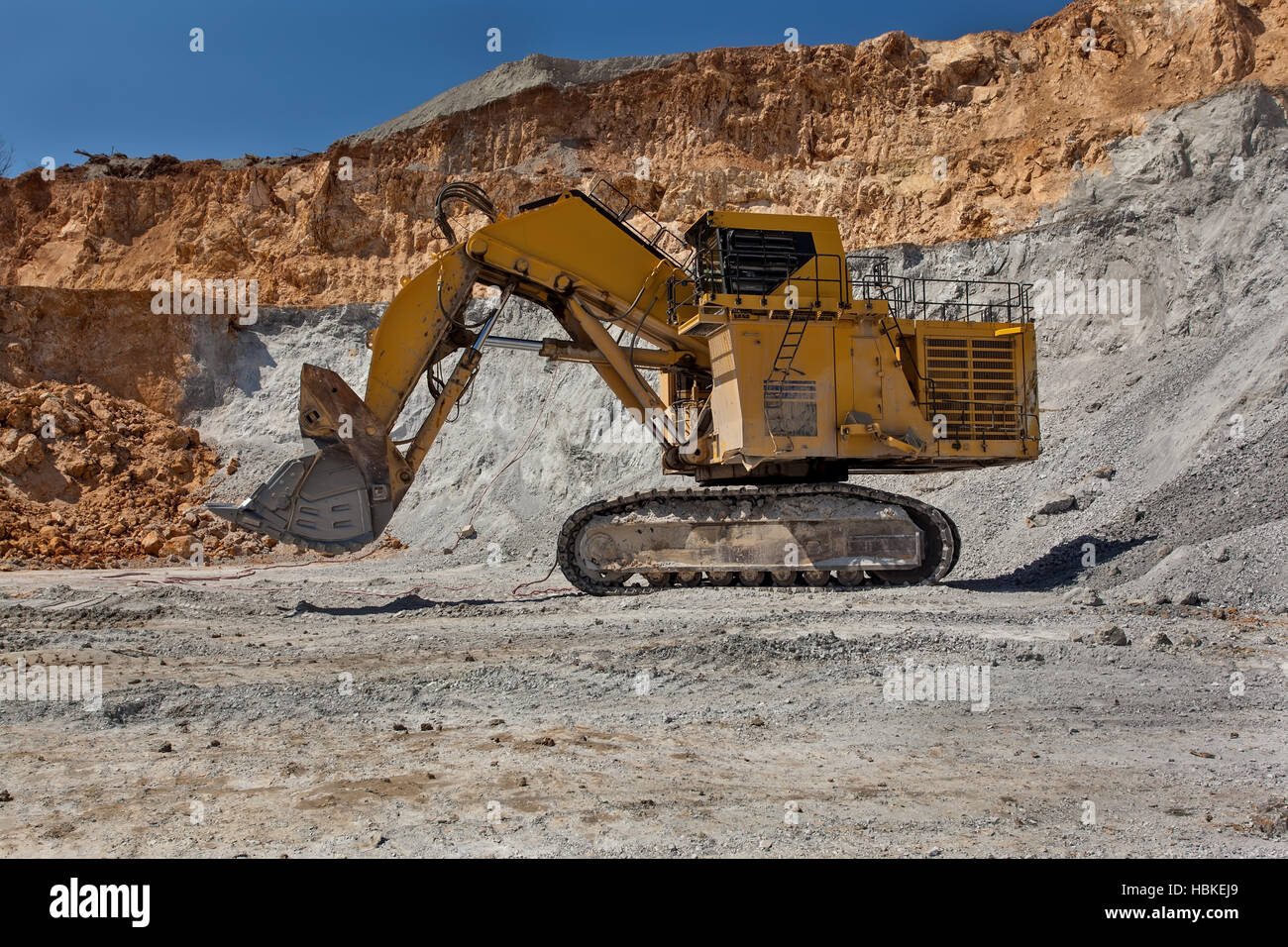 Bor, Serbia - April 15.2015 Group of tourists visiting the Open pit copper mineVeiliki Krivelj at Bor, Serbia. A close encounter with a large excavato Stock Photo