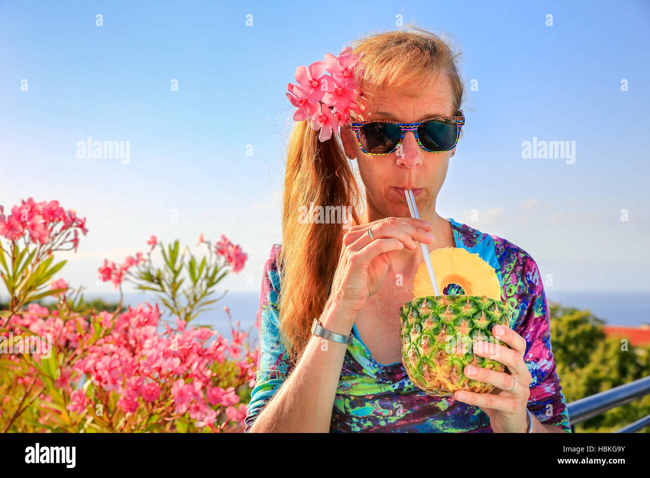 Caucasian woman drinking pine apple juice Stock Photo