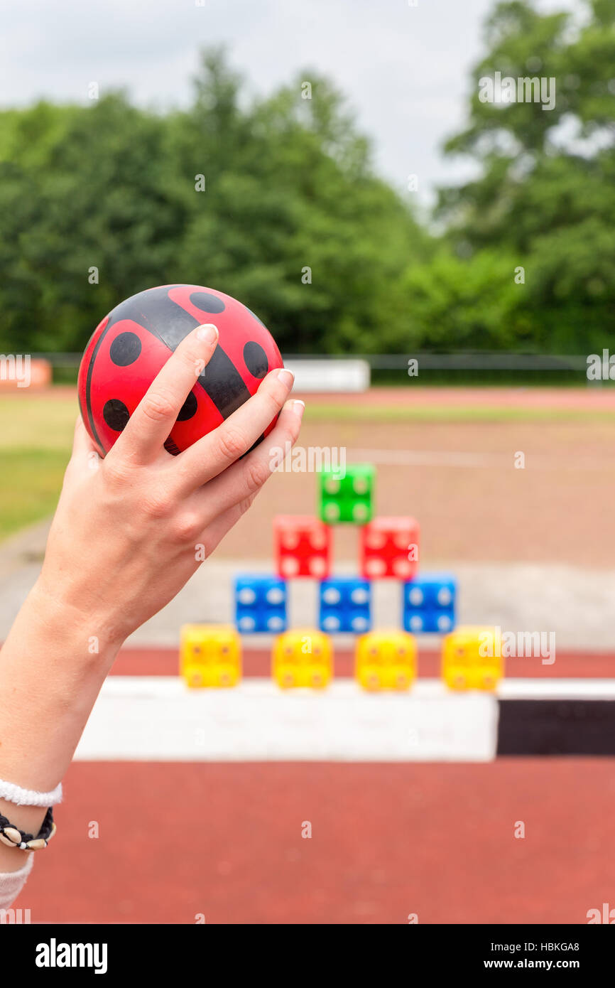 Arm with ball to throw off colored blocks Stock Photo