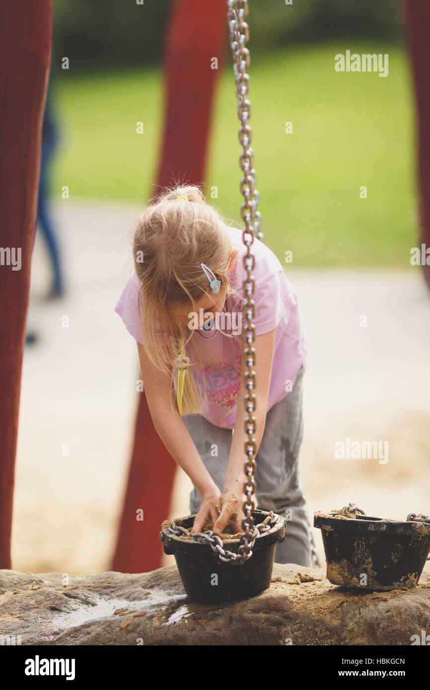 Young blond girl on playground Stock Photo