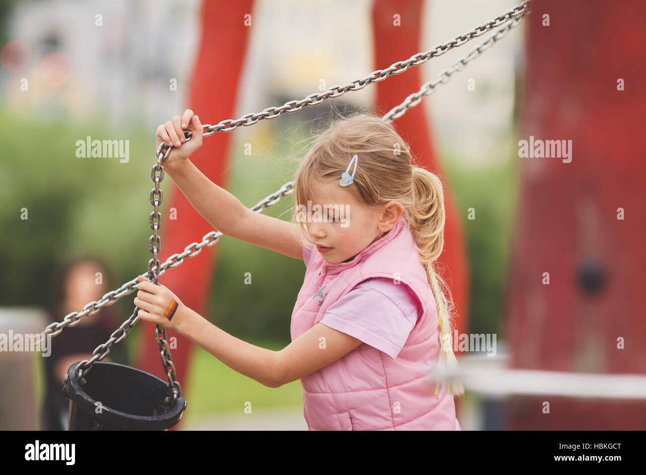 Young blond girl working on playground Stock Photo