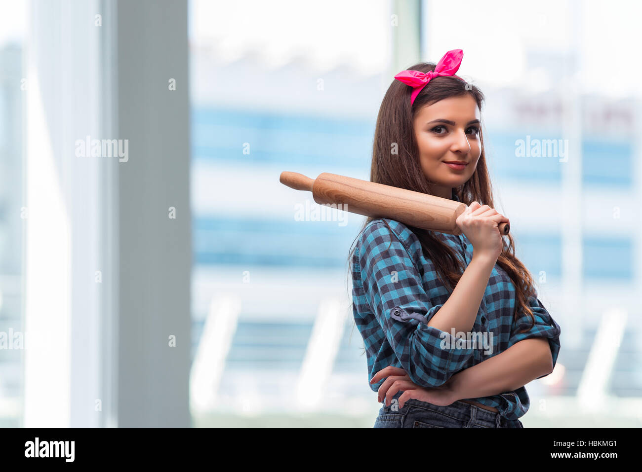 Woman with rolling pin in the kitchen Stock Photo