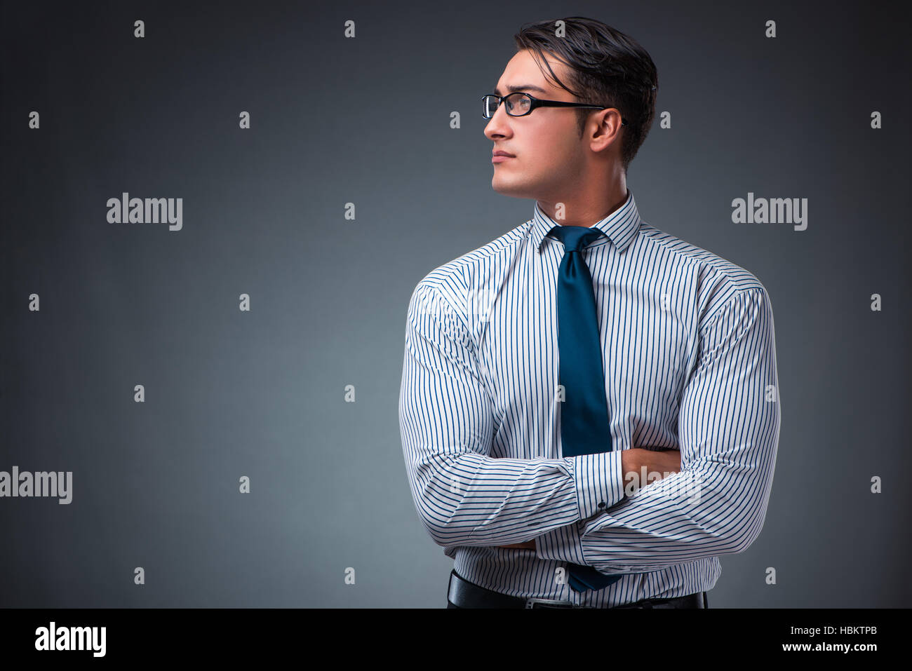 Handsome businessman against gray background Stock Photo - Alamy