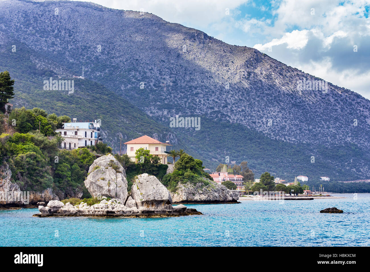Houses rocks and mountain at greek sea Stock Photo