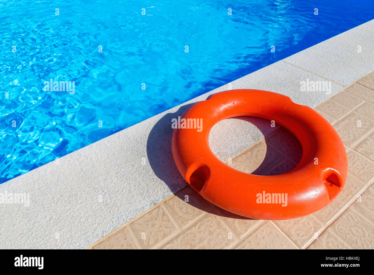 Orange life buoy lying at swimming pool Stock Photo Alamy