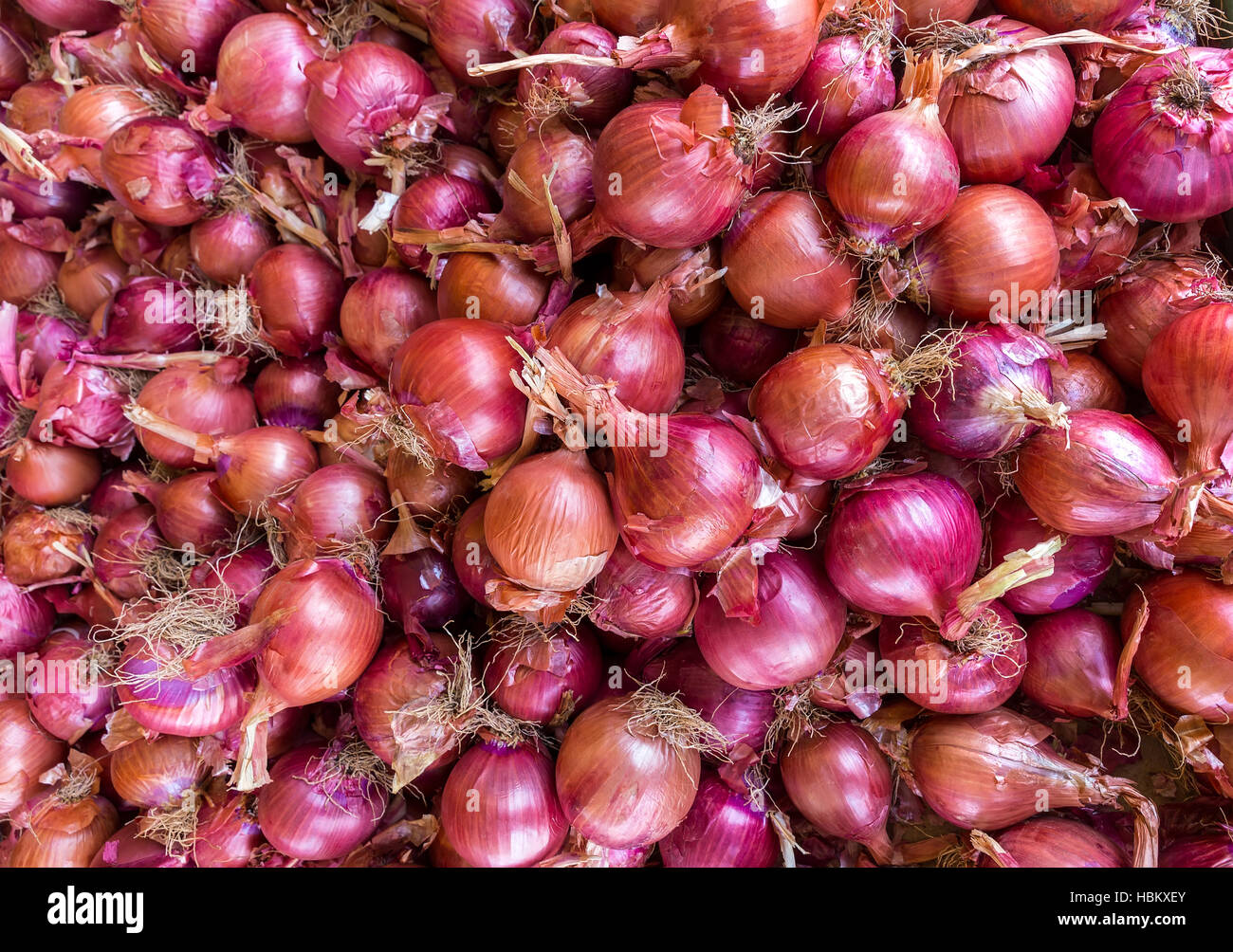 Heap of red onions on market Stock Photo