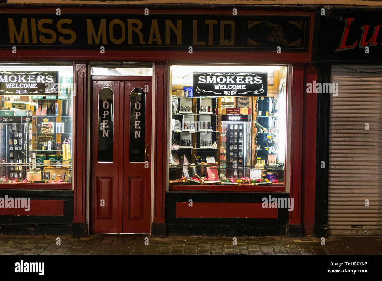 Smokers Miss Moran's tobacco shop at night, Belfast, Northern