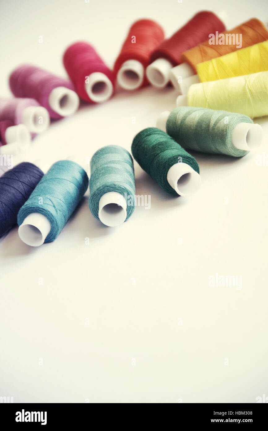 Sewing colored threads Stock Photo - Alamy