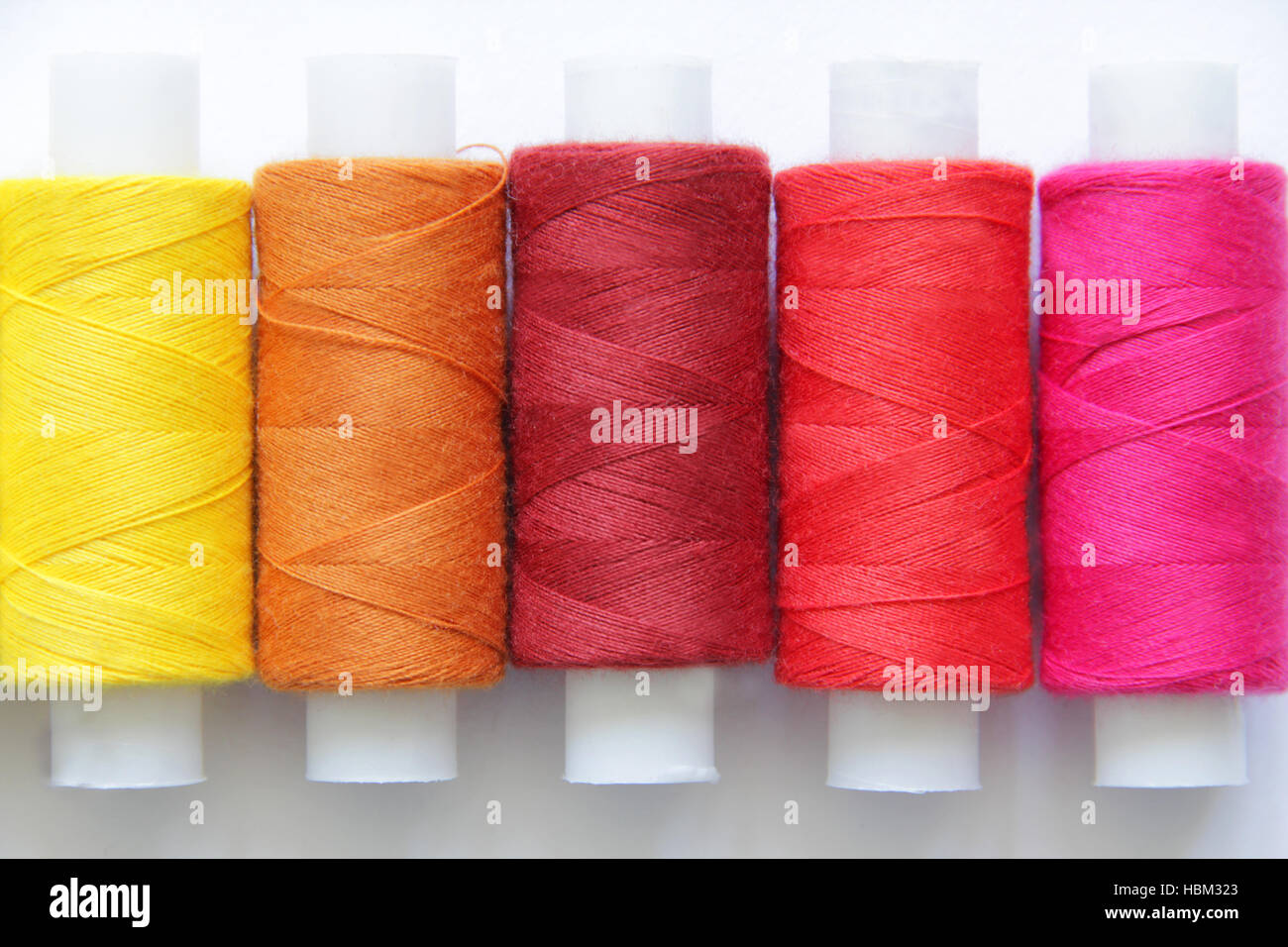 Sewing colored threads Stock Photo - Alamy