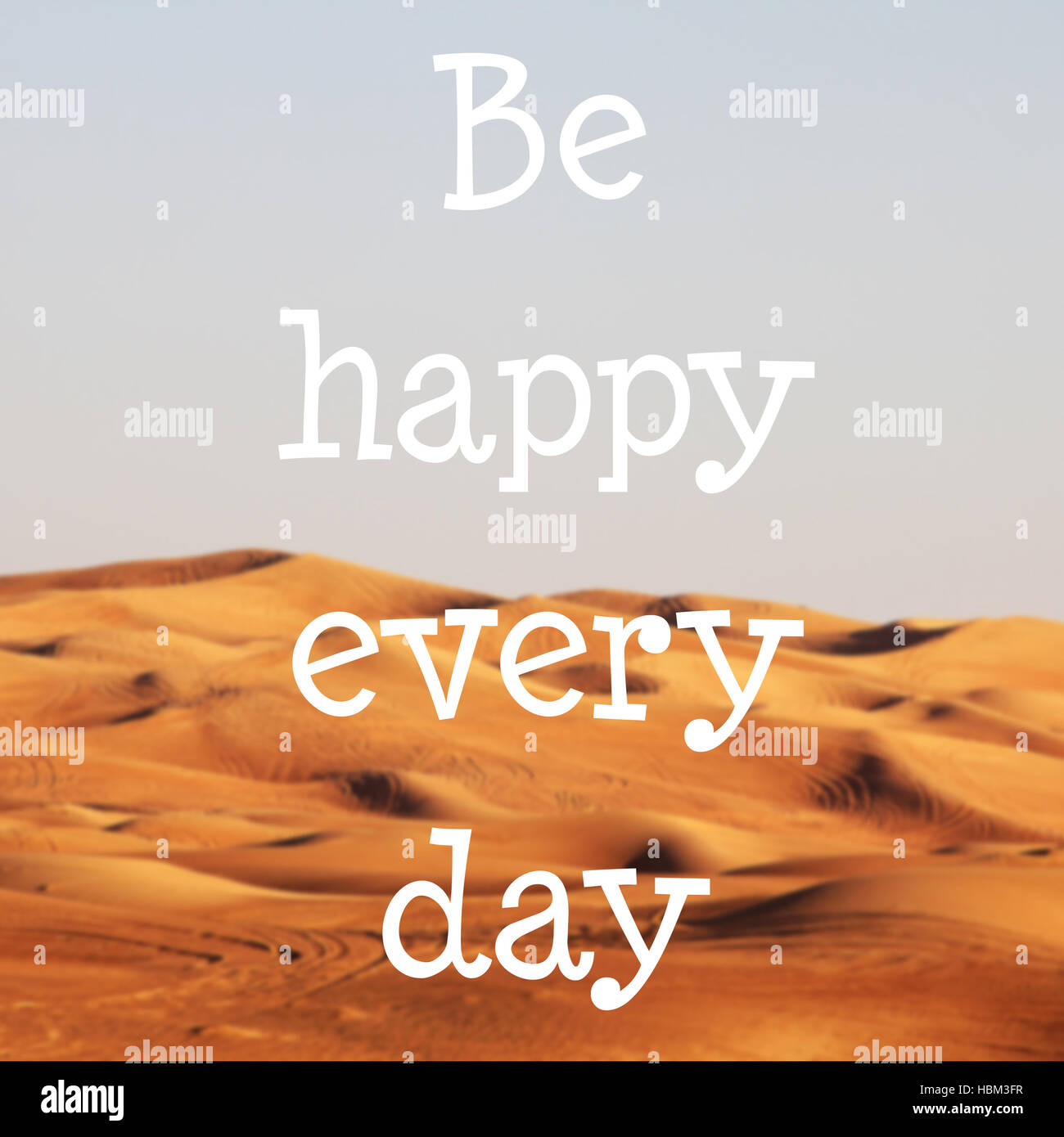 Blured desert with text: Be happy every day Stock Photo