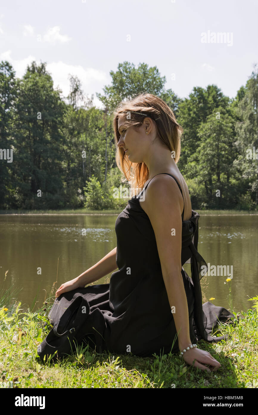 woman with black dress on the lake Stock Photo