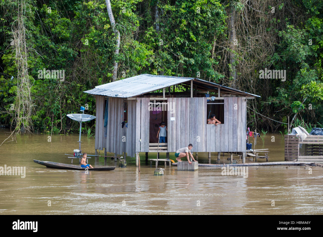 Wooden house on stilts along the Amazon river and rain forest, Brazil Stock Photo
