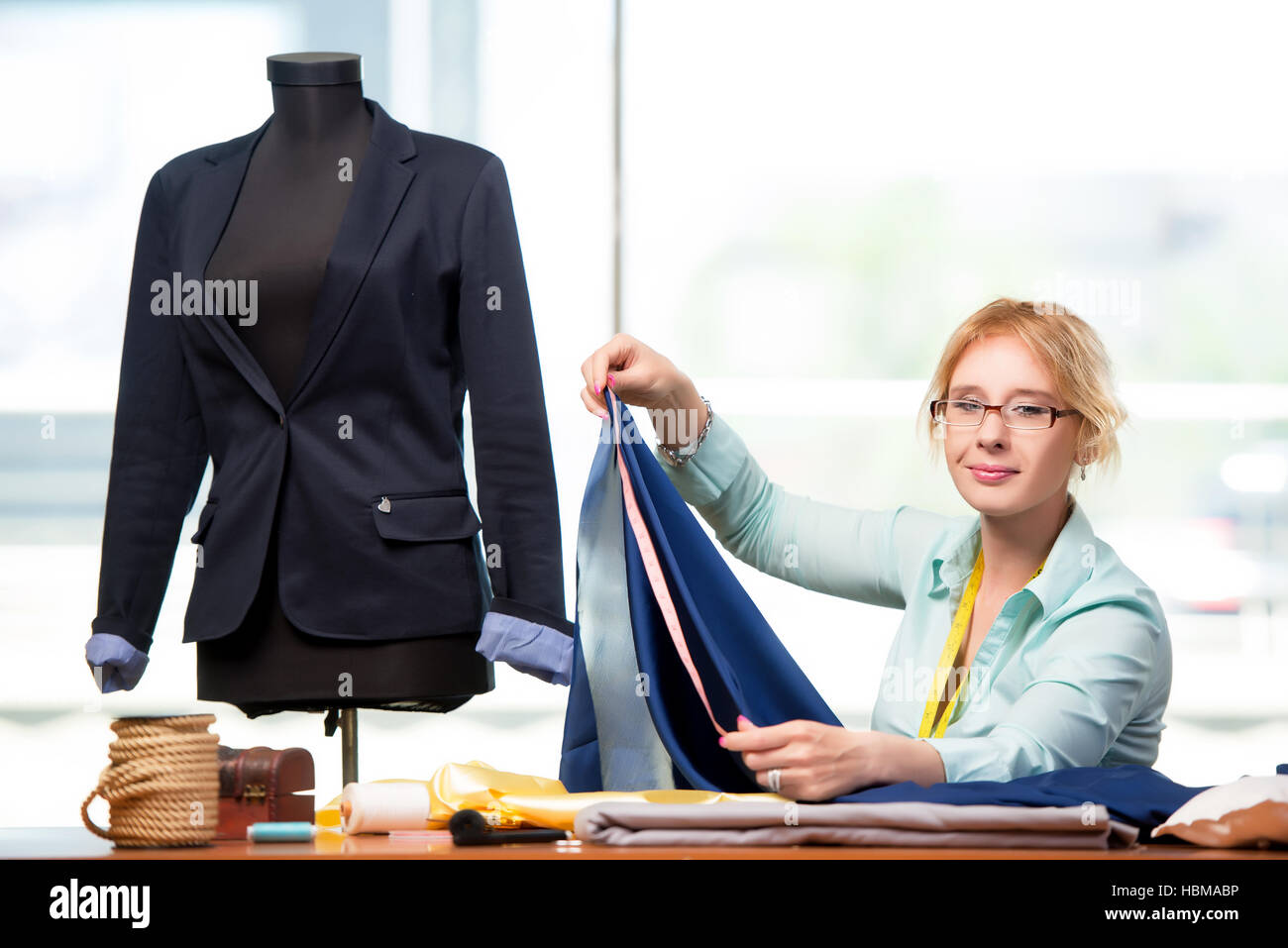 Woman tailor working on new clothing Stock Photo - Alamy