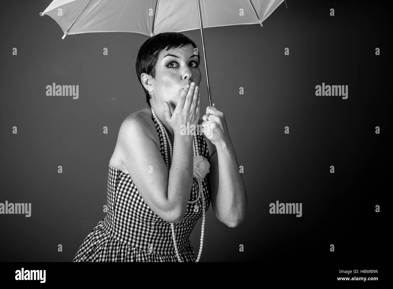 Cheerful girl vintage 50s dress with white umbrella over blue ...